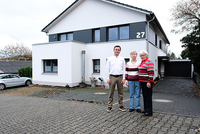 Thorsten, Angela und Elsa Küfner vor ihrem Mehrfamilienhaus